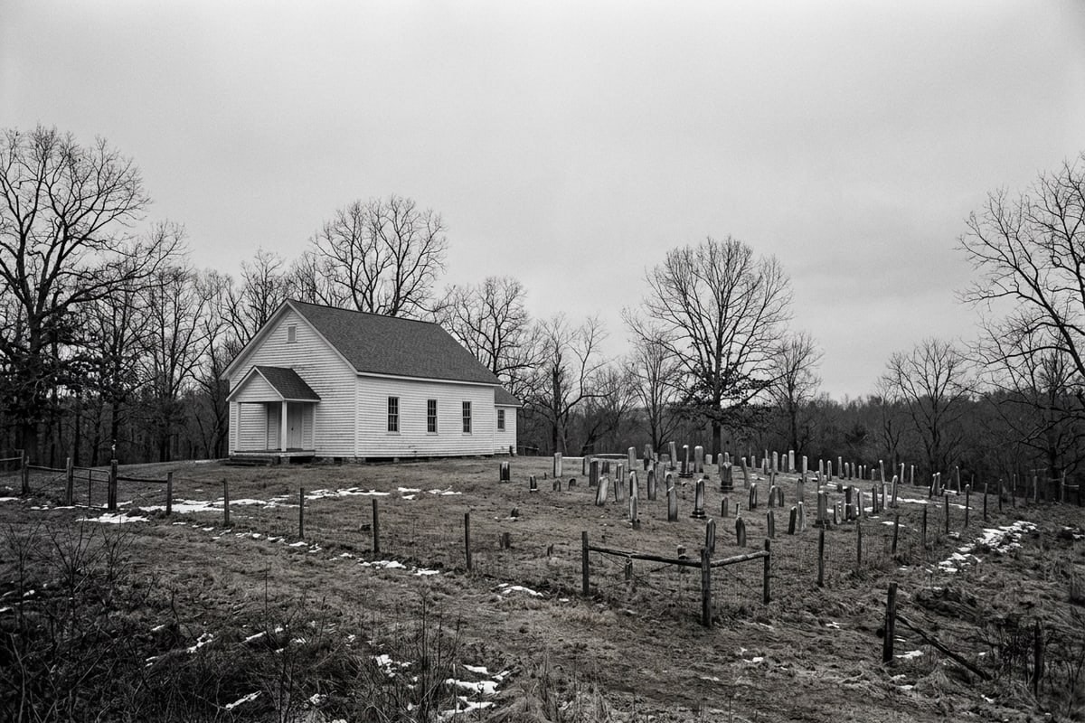 A small white country church and old graveyard on a bare winter hillside in the North Carolina piedmont